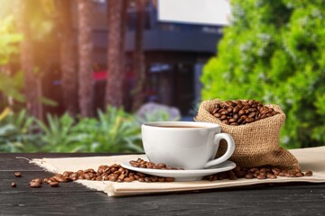 Cup of hot aroma coffee with roasted beans