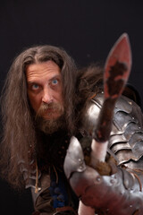 Vertical composition. Portrait of a medieval knight with a characteristic historical appearance...