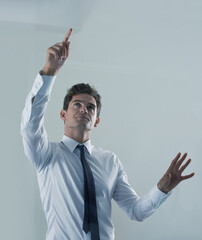Future, interface and business man user in studio on gray background for touchscreen biometrics. Internet, tech or virtual and young employee pointing to access database or metaverse information