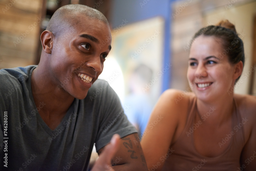 Poster Happy, man and woman in cafe for talking, smile and laughing together in conversation. People, discussion and communication in meeting diverse, friends and chat while relaxing or enjoying restaurant