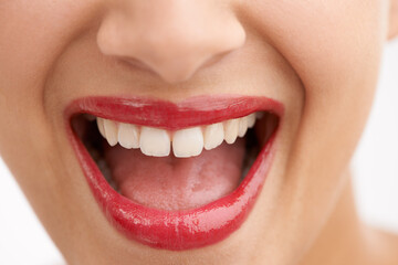 Happy woman, teeth and red lipstick with makeup for beauty, cosmetics or dental care on a white studio background. Closeup of person or model in satisfaction for lip gloss, glow or tooth whitening