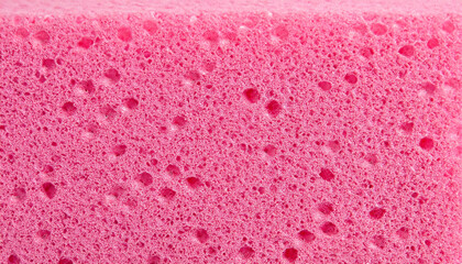 Texture of a porous pink sponge close up. Cellulose pink sponge. micro plastic made from foam - obrazy, fototapety, plakaty