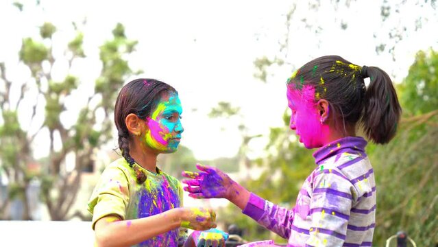 Cheerful young kids celebrating Holi festival, kids playing with colors during Holi Color festival
