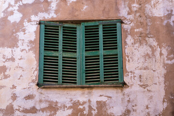 Fototapeta na wymiar wooden, green, old shutters on the window. Mallorca. Majorka, Spain