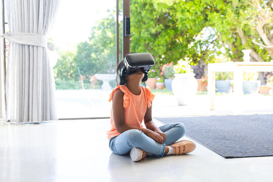 Biracial girl explores virtual reality at home
