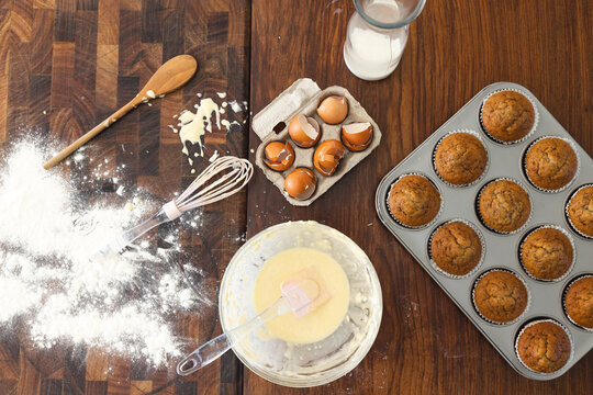 Baking ingredients and utensils are spread out on a kitchen table