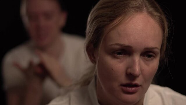 A man is yelling to a deppressed woman. The are in the middle of hassle because of money. She is paralyzed and she wants to divorce him.