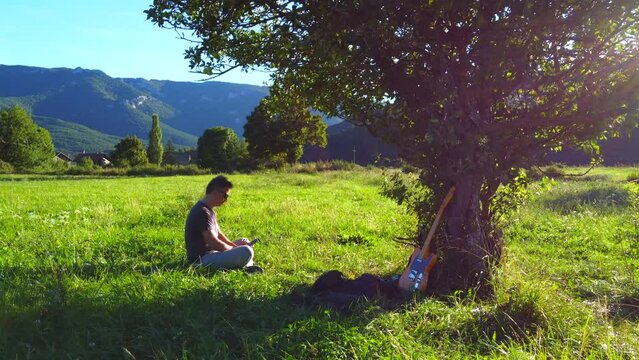 Man relaxing in the nature under an apple tree