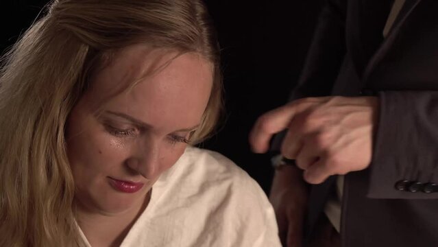 A boss sexually harassing his employee. Giving her inapropriate demands, touching her and being sleezy. A woman is filled with disgust feeling very uncomfortable.