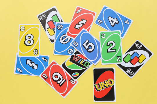 Bangkok, Thailand : August 13, 2023 : A set of colorful Uno game cards on yellow background. Uno is a shedding-type card game originally developed in 1971 by Merle Robbins.
