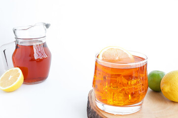 Glass of tasty cold ice tea and fresh lemon on white background. lemon against a background. copy...