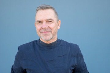 Close up portrait of a middle aged man looking friendly at the camera