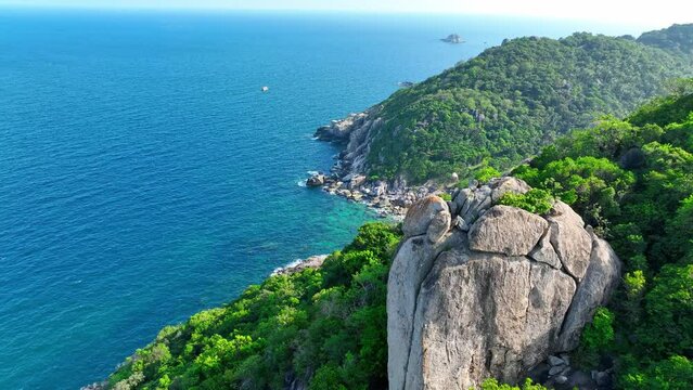 Experience serenity on Koh Tao's tranquil shores, where crystal-clear waters meet golden sands under the warm Thai sun. Flight over the ocean. Cinematic footage. Beach background. 4K UHD.

