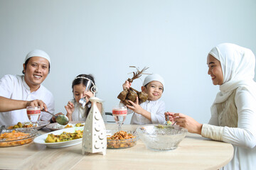Family enjoying special food at dining room during Eid Mubarak moment.