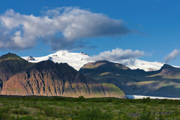 A landscape of mountains and a glacier