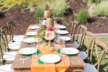 Tropical Theme Table Setting with Pineapple Centerpieces and Shells