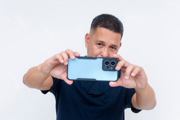 A middle aged asian man taking a landscape mode photo with his high-end smartphone. Advertisement of phone camera features and lens. Isolated on a white background.