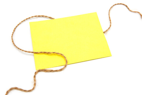 Yellow greeting card hangs on a rope. Copy space. Free space for text.