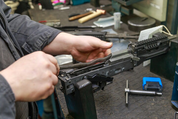 Assembling firearms by a factory worker in the workshop.
