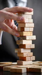 Foto auf Leinwand Planning, risk and strategy in business, businessman gambling placing wooden block on a tower © Lucky Ai