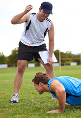 Men, push up and personal trainer on grass for fitness with clipboard for stats, progress or...