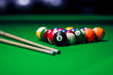 Many colorful billiard balls and cue on green table - 746311779