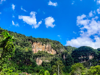 Fototapeta premium View of the Harau Valley with cliffs covered with green plants and trees during the day