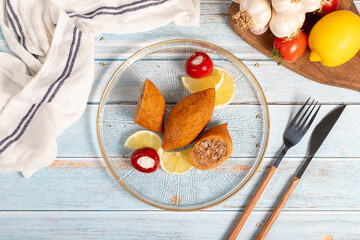 Stuffed meatballs. Appetizer dishes. Kibbeh on blue wooden background. local name içli köfte. Top view