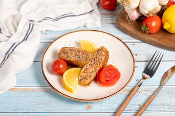 Kadinbudu meatballs. Appetizer dishes. Traditional Turkish meatballs on blue wooden background. local name kadınbudu köfte