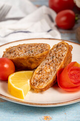 Kadinbudu meatballs. Appetizer dishes. Traditional Turkish meatballs on blue wooden background. local name kadınbudu köfte. Close up