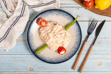 Olive oil and spicy appetizer. Appetizer dishes. Atomic dish with spicy yoghurt on blue wooden...