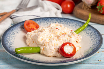 Olive oil and spicy appetizer. Appetizer dishes. Atomic dish with spicy yoghurt on blue wooden...
