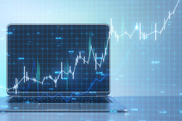 A stylish laptop displaying a rising stock market graph on screen with digital tech background...