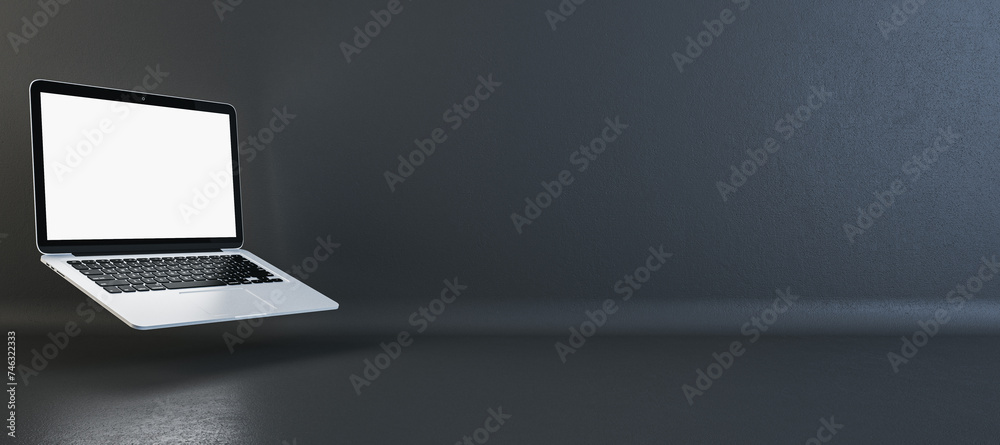 Poster wide-angle view of a silver laptop with a blank screen on a dark background, tech presentation conce