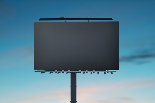 Blank dark billboard ready for advertising content, set against a sunset sky. Visual marketing concept. 3D Rendering
