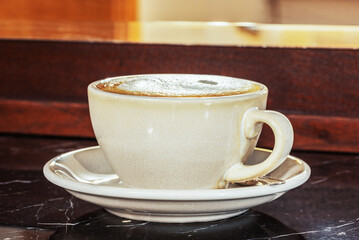 Cup of coffee cappuccino on bar in cafe