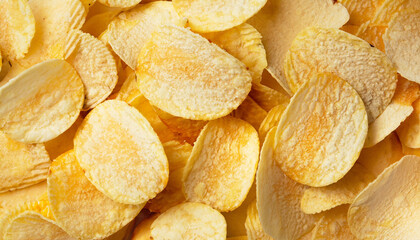 Crispy fresh potato chips, snacks background. Top view, flat lay. Banner with sliced potatoes; junk food