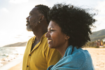 Beautiful mature black couple of lovers dating at the seaside - Married african middle-aged couple...