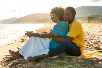 Beautiful mature black couple of lovers dating at the seaside - Married african middle-aged couple...