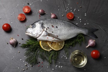 Fresh dorado fish and ingredients on grey table, flat lay
