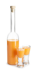 Bottle and shot glasses with tasty tangerine liqueur isolated on white