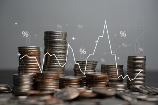 Stacks of coins are contrasted against a digital graph, symbolizing economic growth inflation trends and financial planning. The image captures the essence of investment growth and market analysis.