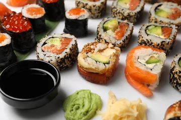 Foto auf Acrylglas Set of delicious sushi rolls on white background, closeup © New Africa