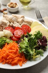 Balanced diet and healthy foods. Plate with different delicious products on table, closeup