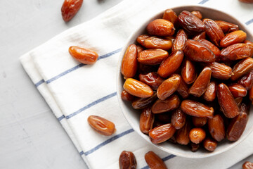 Organic Raw Date Fruit in a Bowl, overhead view. Flat lay, from above, top view. Copy space.