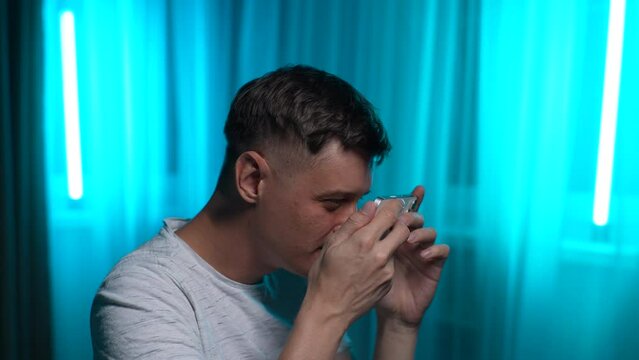 Young man squints and sees poorly without spectacles. Male trying look closer at smartphone screen. Guy with poor eyesight looking at mobile phone screen. Concept poor eyesight, glasses, ophthalmology