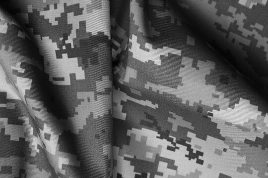 Texture of crumpled camouflage fabric as background, top view. Black and white effect