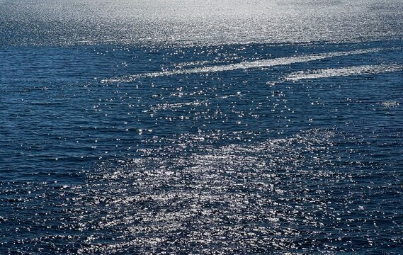 Blue sea water glittering shining surface. 