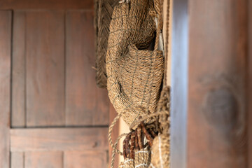 an old straw bag hanging on the wall