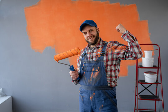 Painter bearded man over wall background celebrating a victory in winner position